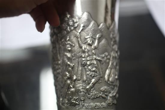 Two Indian white metal beakers, each embossed with scenes of women making offerings to Lord Shiva